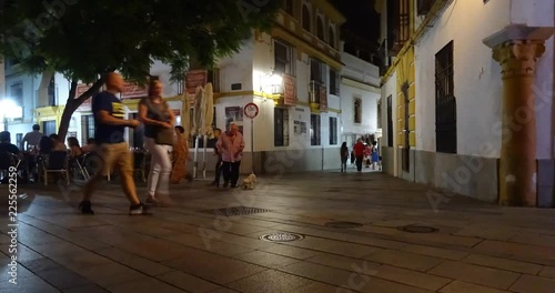 Crowded pedestrian street in the old town of C√≥rdoba, Spain, during a summer night. Lot of tourists and locals enjoying the bars and restaurants or just walking the old jewish quarter streets. photo