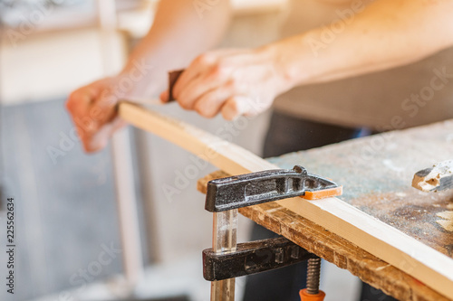 carpenter working with wood, close up on hands