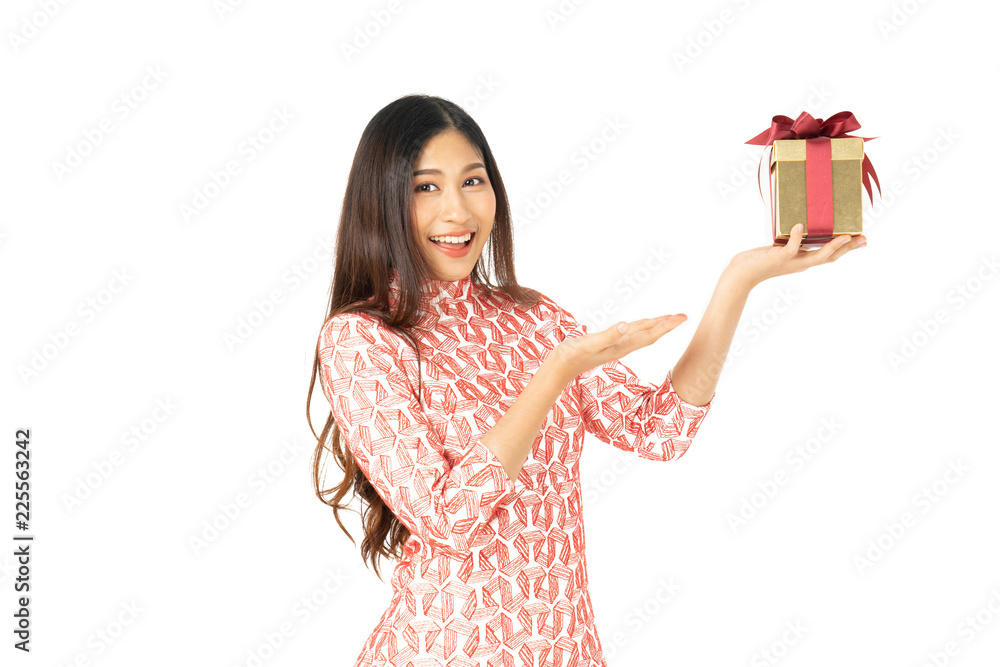 Photo of asian curious woman in red dress rejoicing her birthday or new year gift box. Young woman holding gift box with red bow being excited and surprised holiday present isolated white background Photo of asian curious woman in red dress rejoicing her birthday or new year gift box. Young woman holding gift box with red bow being excited and surprised holiday present isolated white background