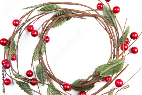 A top closeup view of  christmas  round twigs with leaves and red berries