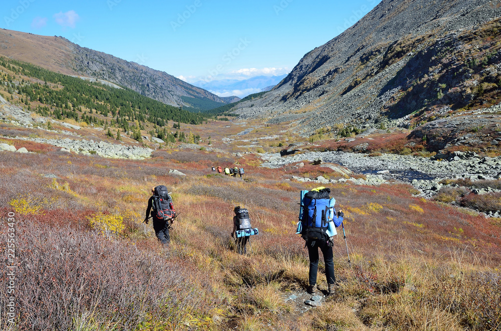  Altai territory, Ust-Koksinsky district, Russia,  tourists with backpacks walking along the riverbed of Acchan (Akchan) in september