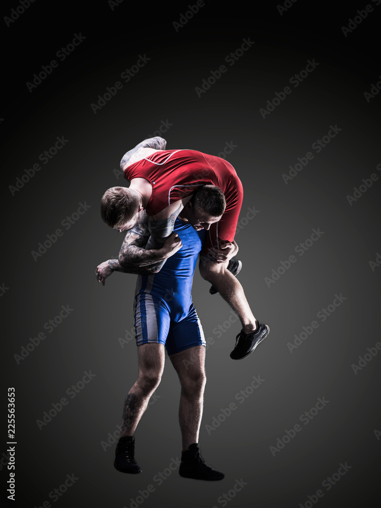 two wrestlers figting isolated on black back