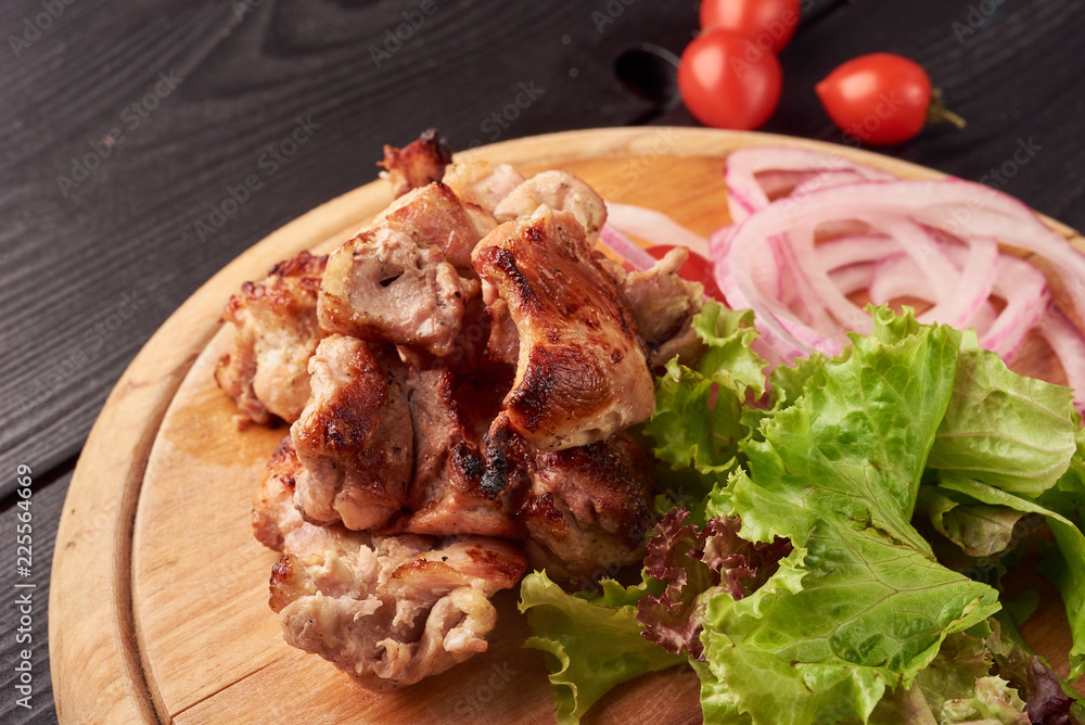 Barbecue skewers with juicy meat and salad and tomatoes on plate Barbecue skewers with juicy meat and salad and tomatoes on plate