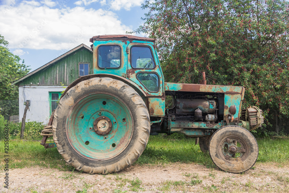 Old rusty tractor in the summer village Old rusty tractor in the summer village