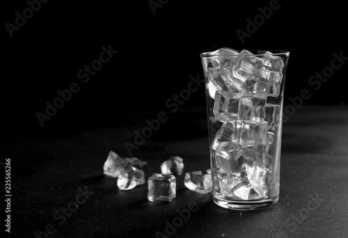 Glass with ice on a black slate