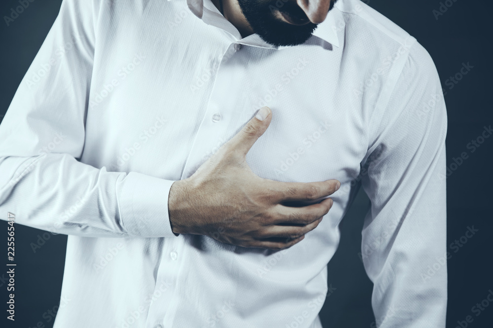 Man having heart ache holding hand Man having heart ache holding hand