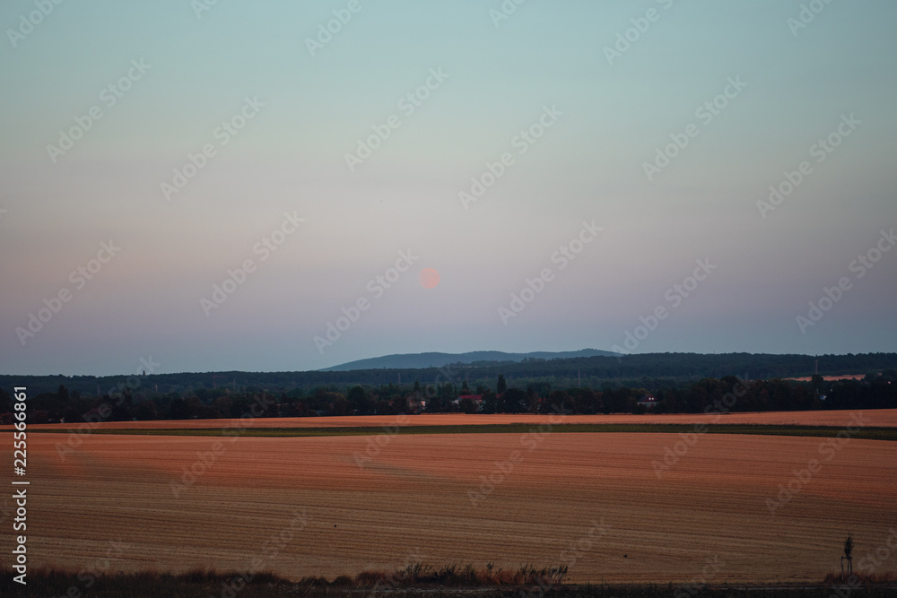 Moody full moon rise with open fiel landscape view. Braunschweig, Germany