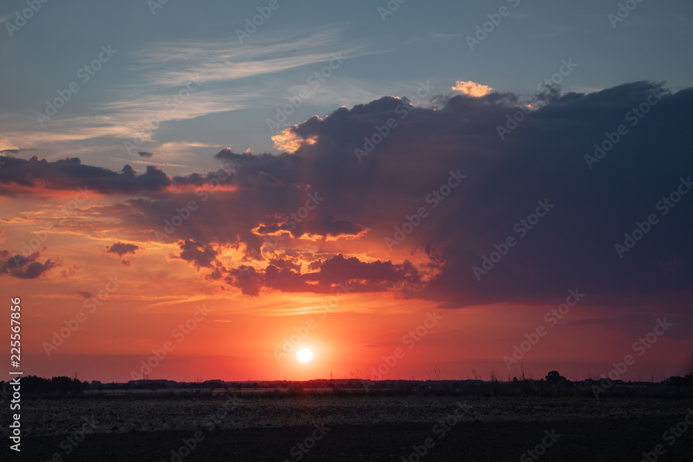 Landscape sunset view with rain and dramatic clouds at the same time. Countryside panorama fields. Braunschweig, Germany Landscape sunset view with rain and dramatic clouds at the same time. Countryside panorama fields. Braunschweig, Germany