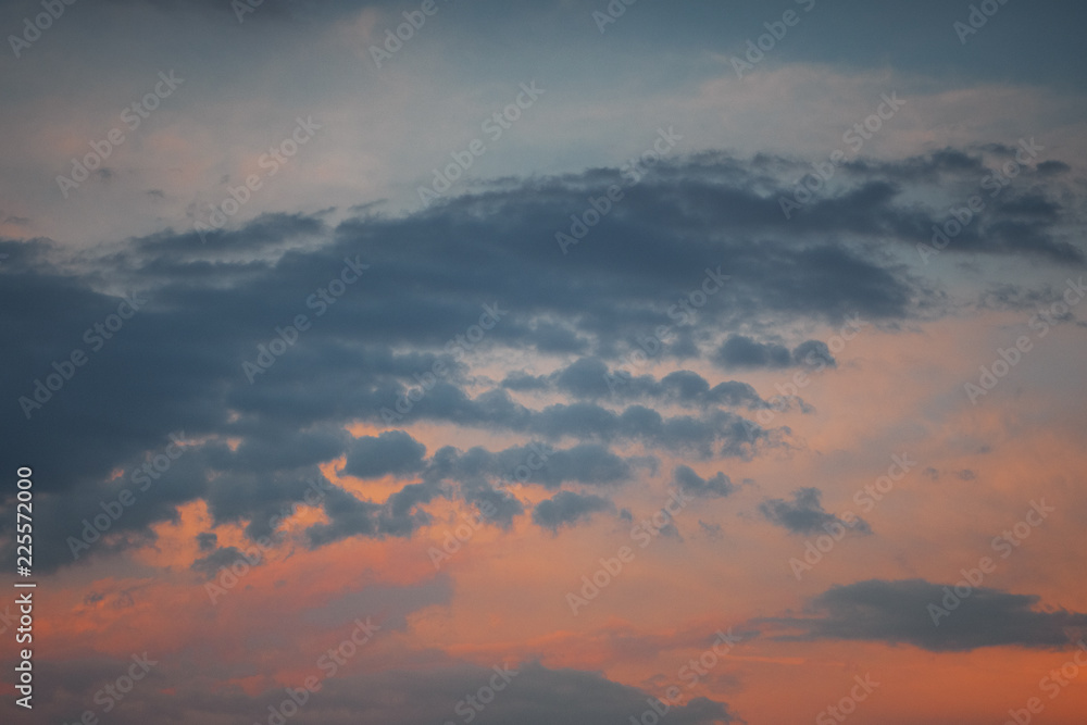 Obraz premium Colorful sunset sky with textures fluffy clouds and orange and blue color tones. Summer evening sunset light. Braunschweig, Germany