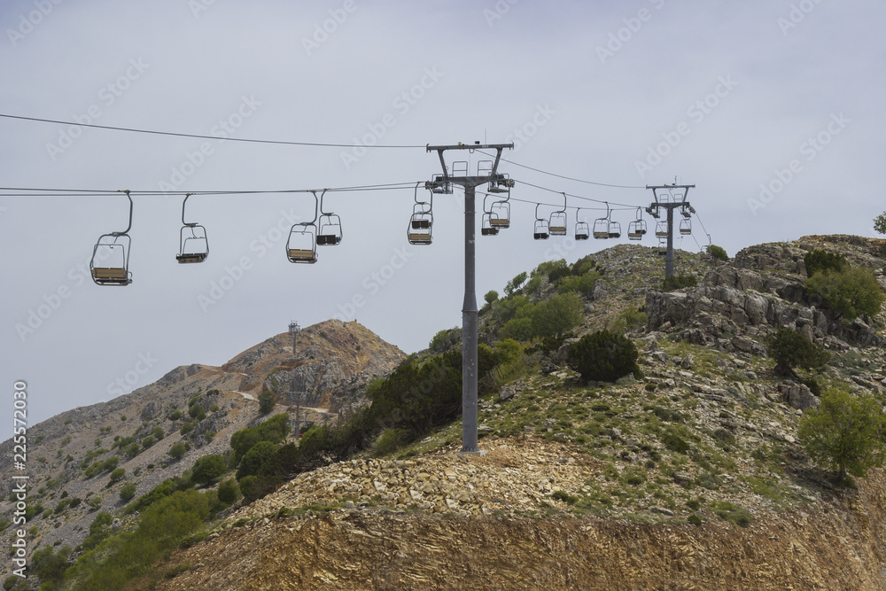 empty chair lift on the mountainside in summer.