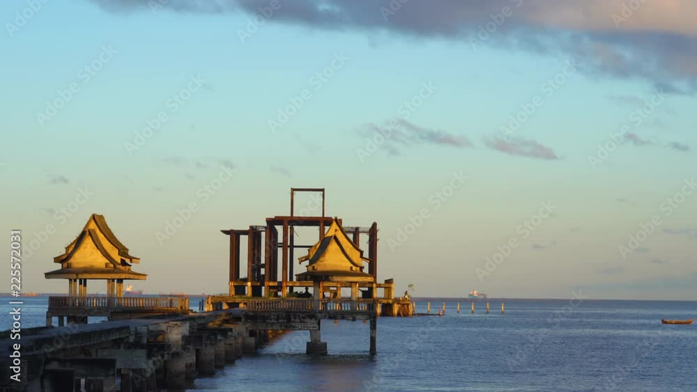 The old bridge into the sea on the beach at sunrise The old bridge into the sea on the beach at sunrise