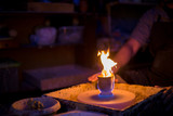 Burning ceramic mug on pottery wheel in workshop, studio. Handmade, art and handicraft concept
