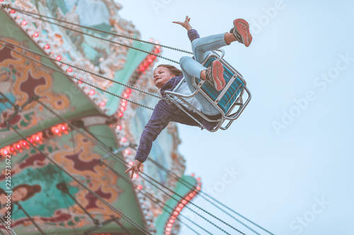 Tableau sur toile Young girl enjoying ride in merry-go-round on Prater in Vienna
