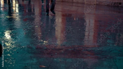 close up people walking in the city street during the heavy rain