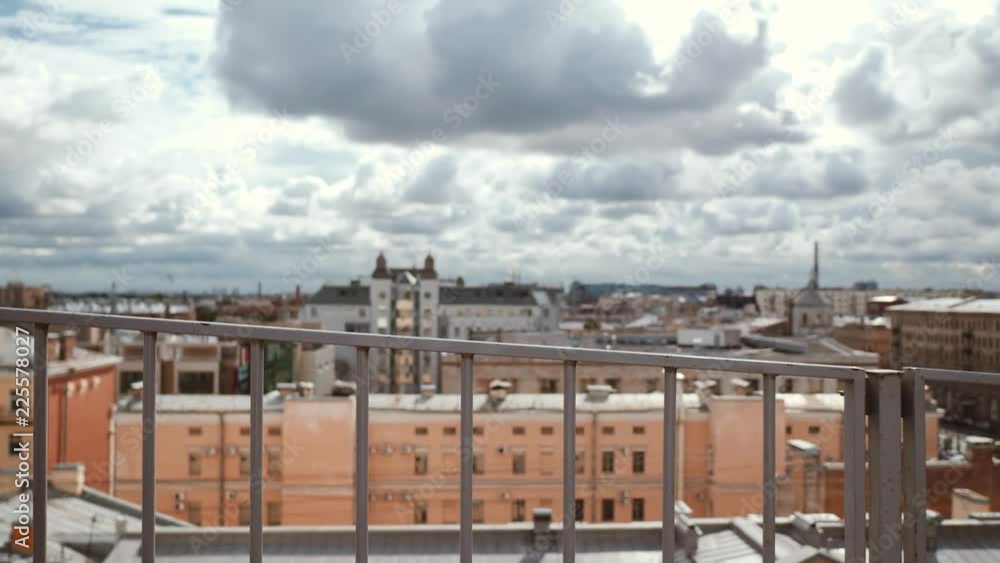 Frozen woman in leather jacket feel cold while standing on the roof in the wind Frozen woman in leather jacket feel cold while standing on the roof in the wind