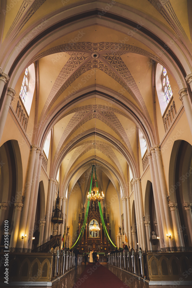 Fototapeta premium Bride and groom at the church during a wedding ceremony