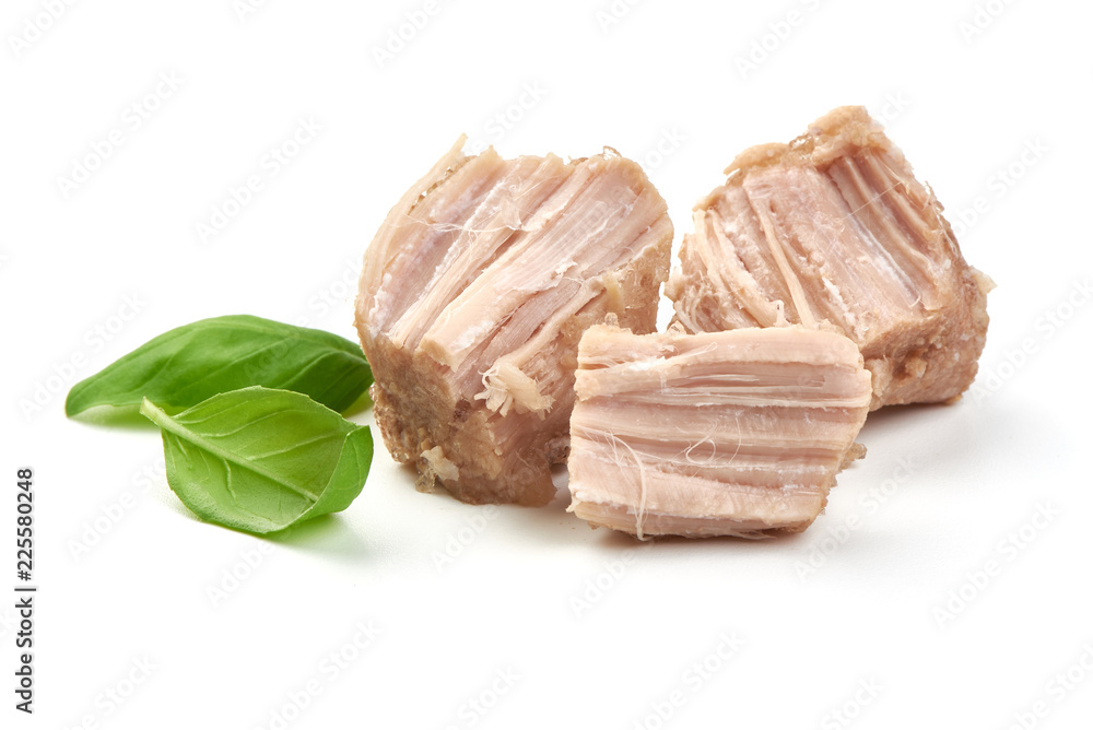 Canned Meat pieces with basil leaves, close-up, isolated on white background Canned Meat pieces with basil leaves, close-up, isolated on white background