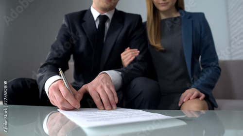 Fotografie Young couple signing business contract, purchase or sale of property, insurance