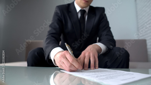 Businessman signing document for purchase or sale of company, private property