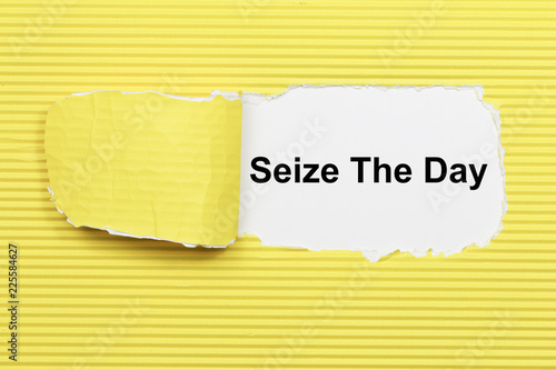 Seize The Day text on paper. Word Seize The Day on torn paper. Concept Image. photo