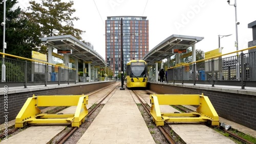 One of Manchester,s iconic yellow trams departing from the Media City UK station. photo