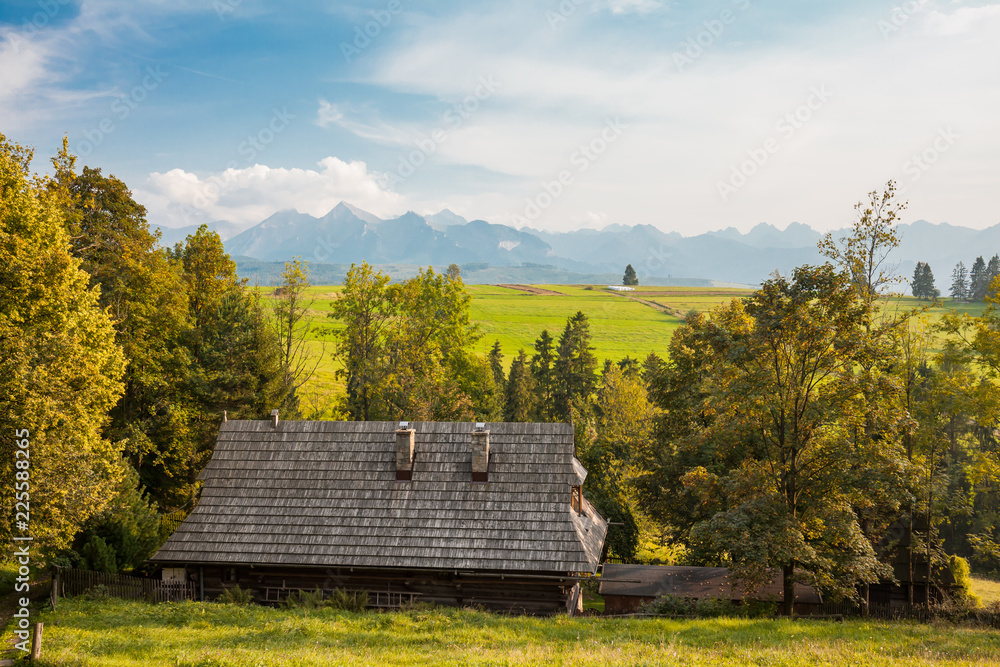 Rural wooden house and Tatra mountains background