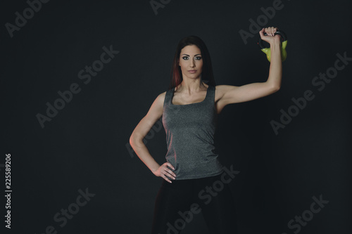 Young female doing swing exercise with a kettle bell. Fitness woman © Augustas Cetkauskas