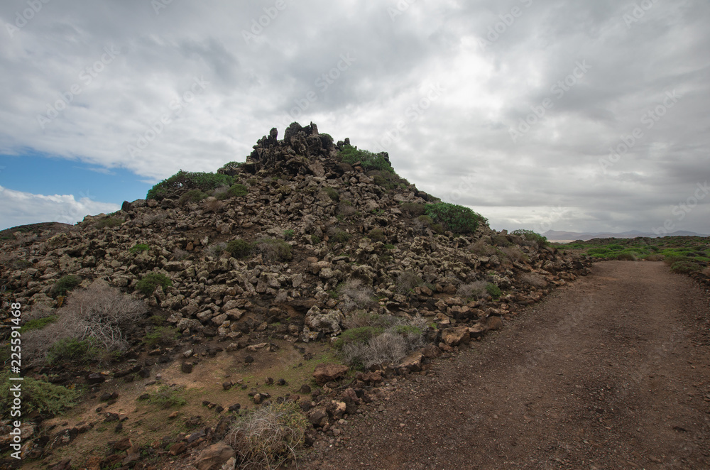 piles of lava rock in the natural oasis of Los Lobos, Canary Islands.