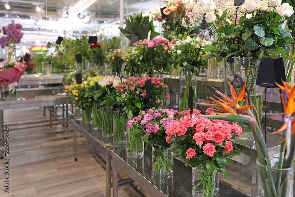 Assortment of beautiful flowers in shop. Florist's workplace