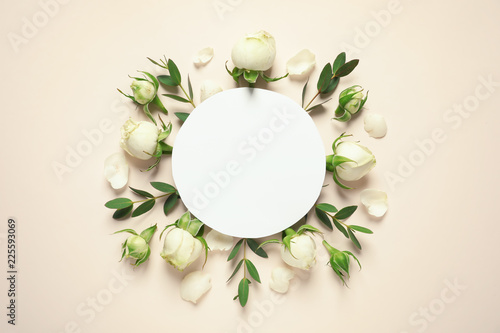 Flat lay composition with beautiful blooming flowers on color background