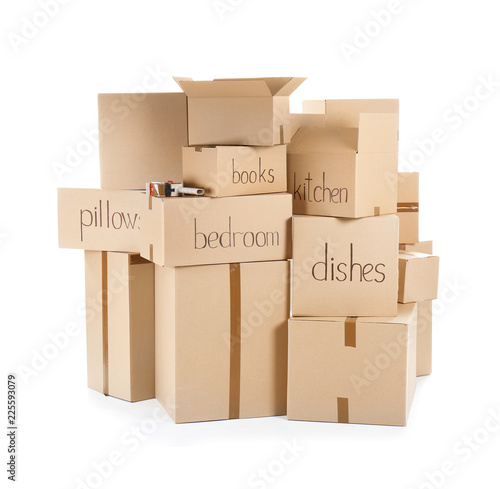 Moving boxes and adhesive tape dispenser on white background