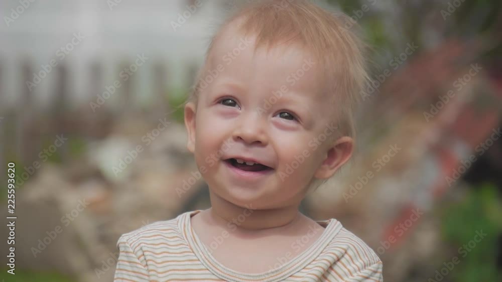 Adorable little happy laughing 1 year old baby boy is looking to camera and smile. Adorable little happy laughing 1 year old baby boy is looking to camera and smile.