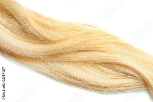 Locks of healthy blond hair on white background