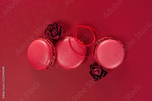 Red macarons decorated with dry roses