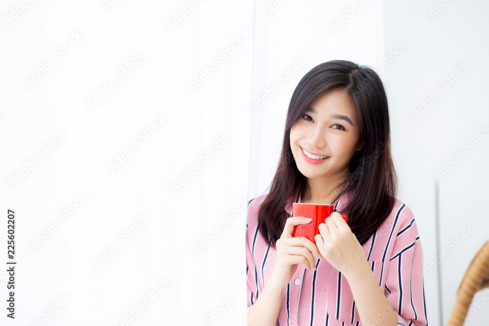 Beautiful of portrait young asian woman with drink a cup of coffee standing curtain window background in bedroom, girl relax in morning at home, lifestyle concept. Beautiful of portrait young asian woman with drink a cup of coffee standing curtain window background in bedroom, girl relax in morning at home, lifestyle concept.