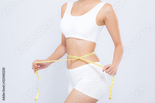 Asian woman diet and slim with measuring waist for weight isolated on white background, girl have cellulite and calories loss with tape measure, health and wellness concept. photo