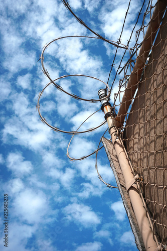 Barbed wire fence with cloudy sky