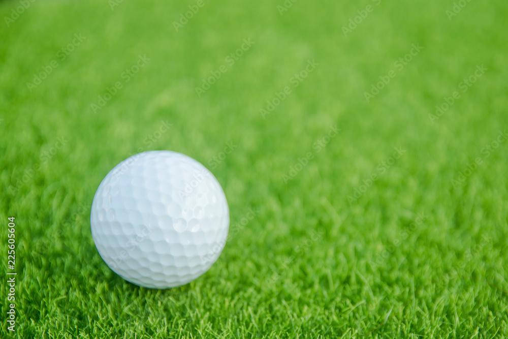 Golf ball on green grass ready to play at golf course. with copy space Golf ball on green grass ready to play at golf course. with copy space