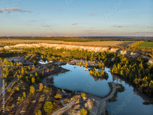 Aerial view of sand quarry in Voronezh region Beliy Kolodets or White Well. Beautiful nature panorama with lake among hills © DedMityay