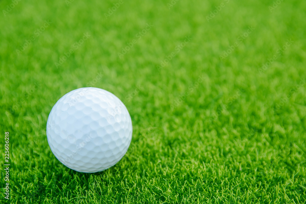 Golf ball on green grass ready to play at golf course. with copy space Golf ball on green grass ready to play at golf course. with copy space