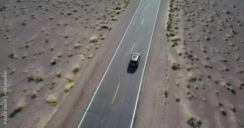 Driving dark SUV car on highway in Death Valley in USA Driving dark SUV car on highway in Death Valley in USA