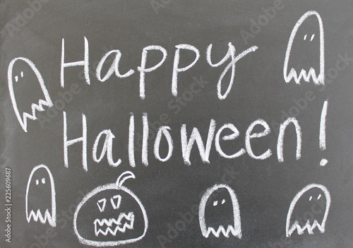 Happy Halloween written on chalkboard with jack o'lantern and ghosts.
