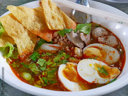 Closeup of fresh spicy noodles soup with tasty broth (Guay Tiao Tom Yum) - delicious and healthy street food in Thailand photo
