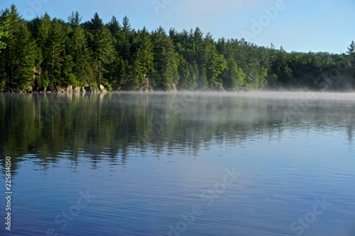 Adirondack Park, New York, USA: The morning mist rises from the waters of Sagamore Lake.
