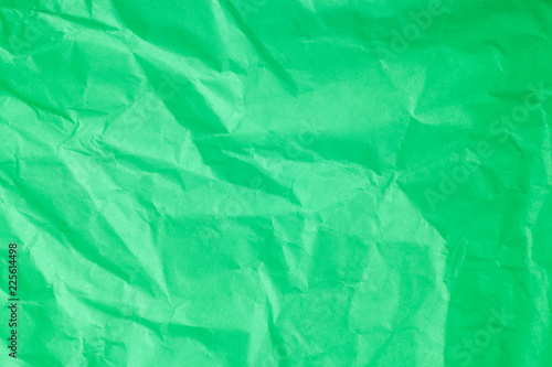 Green crumpled paper background.