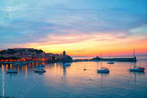 Amazing dramatic sunset sky over small harbour of Collioure, coastal village in the south of France. © DigiHand