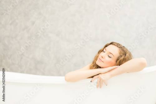 Woman is soaking in the bathtub.Young woman relaxing in bath.beautiful woman lying in bathtub.
