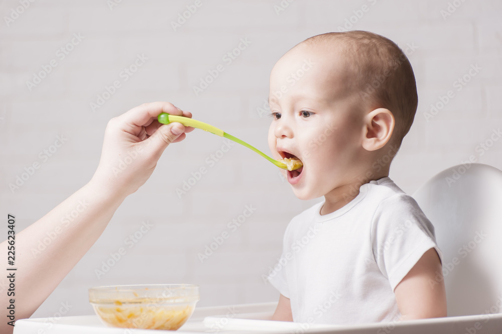 A little baby eats, feeding a small child A little baby eats, feeding a small child