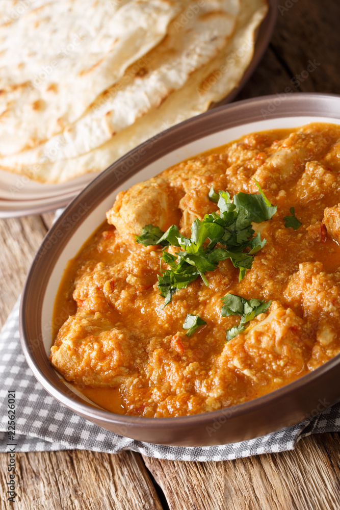 Chicken Changezi is a mughalai dish in which chicken is cooked in wonderful flavours of onion,almond and cashew paste along with curd and cream close-up on a plate. Vertical Chicken Changezi is a mughalai dish in which chicken is cooked in wonderful flavours of onion,almond and cashew paste along with curd and cream close-up on a plate. Vertical
