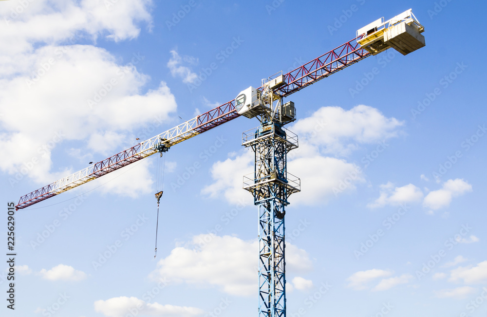 Construction. Tower crane on the sky background. Crane